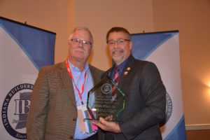Andy Place, Sr. (left) accepts the John C. Hart Award from 2016 IBA President Jim Pressel (right) at the IBA December Board of Directors Meeting.